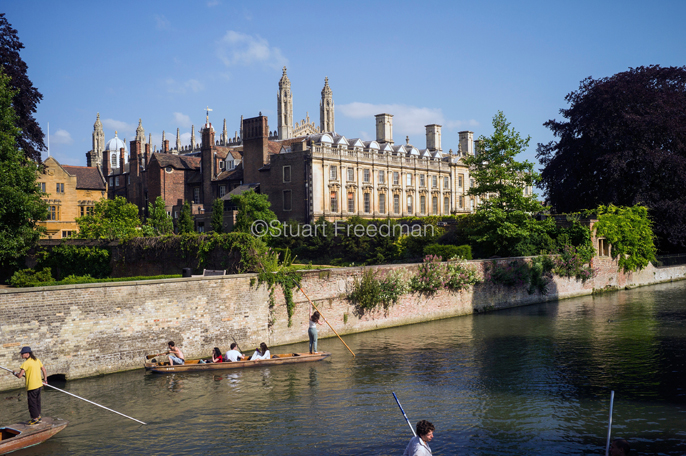 UK - Cambridge - Punts and passengers glide past The Clare College (founded 1326) on the River Cam past the Garret Hostel bridge, Cambridge, UK 