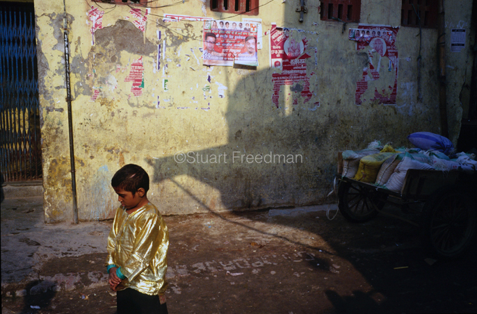 India - New Delhi - A performers son in a gold shirt, Shadipur Depot,
