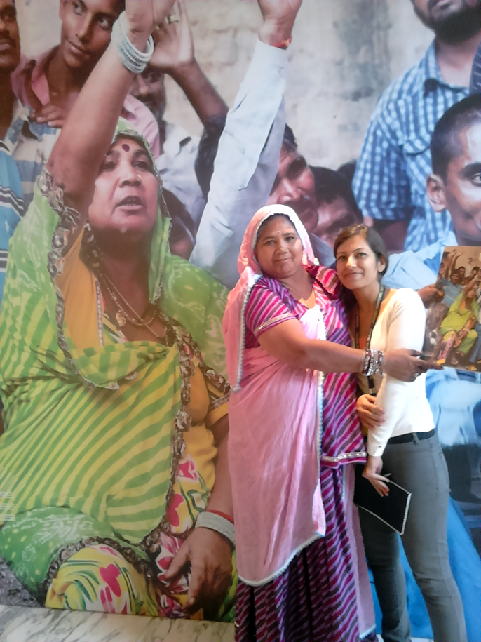 India - New Delhi - Sarbati Das from Kathputli Colony (in front of her cover image used as a poster at the LSE Cities Conference) and the excellent Sunayana Wadhawan
